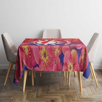 Floral tablecloth in red, pink, and purple with blossom pattern on a dining table