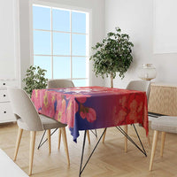 Red blossom-pattern tablecloth with pink flowers and blue-toned accents on chairs