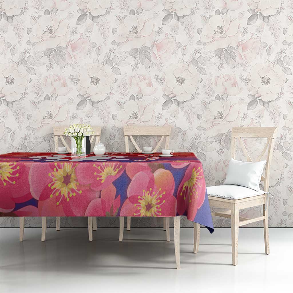 Red and pink floral tablecloth with blossom print on a dining room table