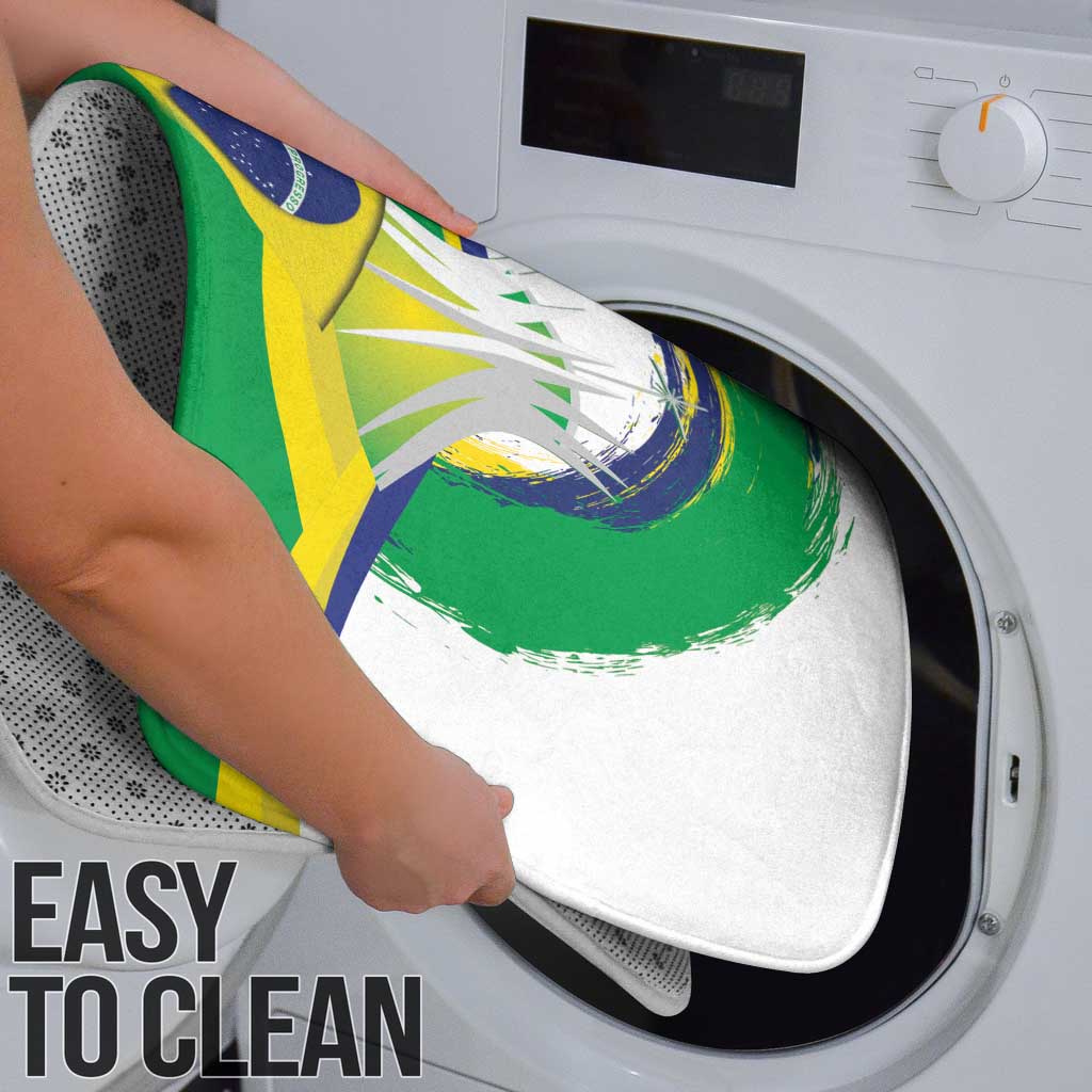 Green bath mat with Brazil crest graphic being placed on washing machine