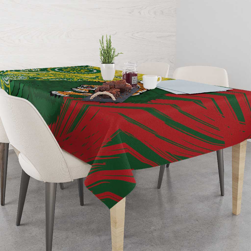 Green and red tablecloth with bold stripe pattern, draped over dining table