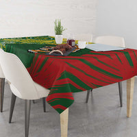 Green and red tablecloth with bold stripe pattern, draped over dining table