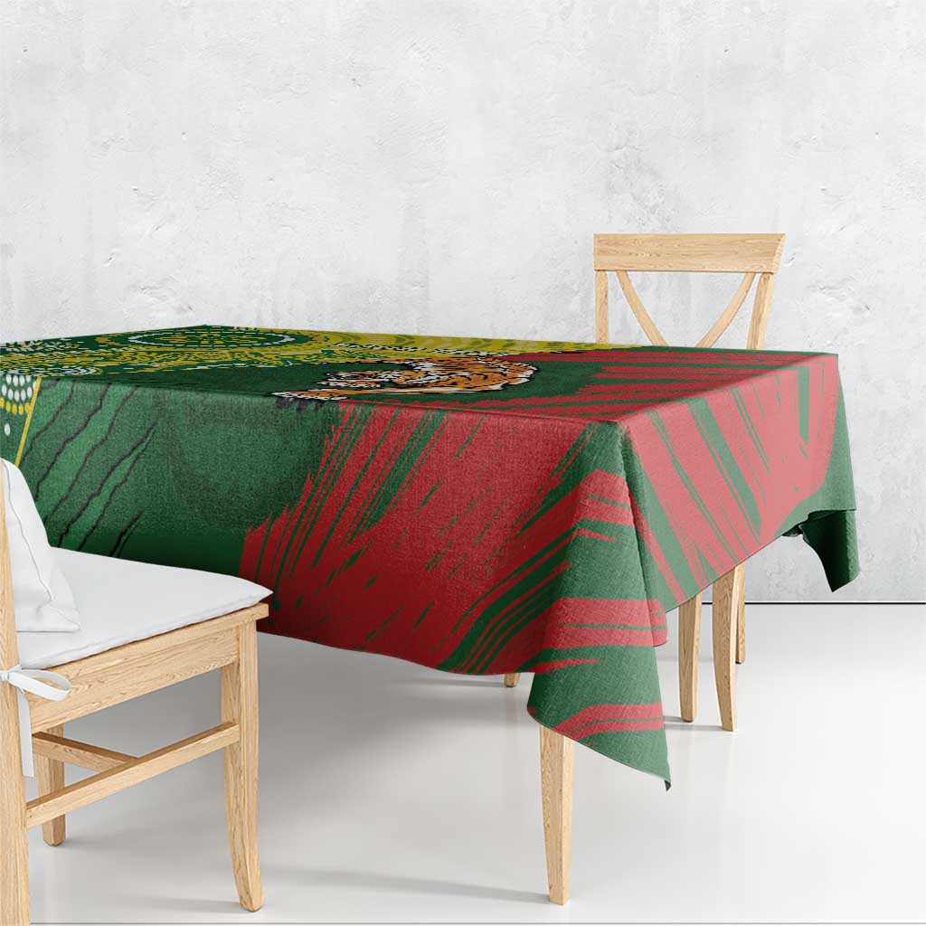 Green and red patterned tablecloth draped over wooden bench and table