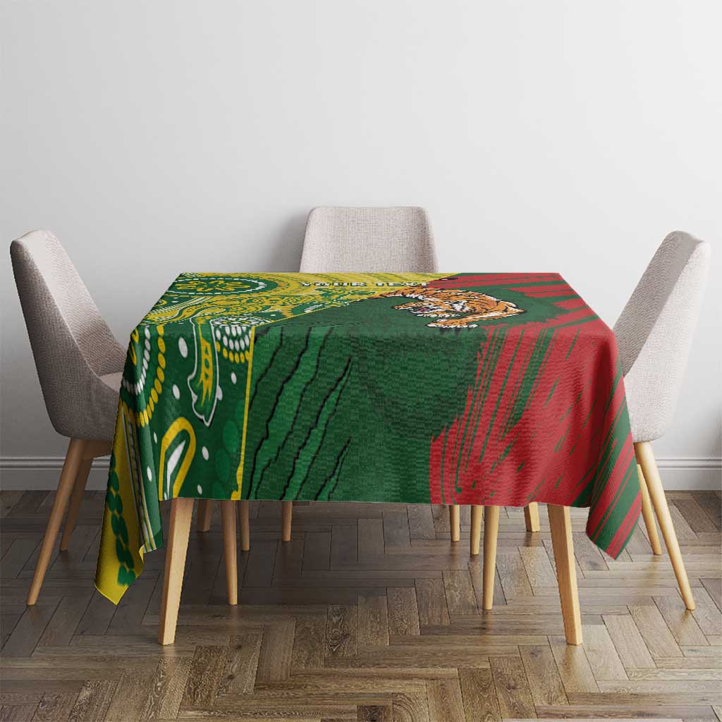 Square tablecloth with green, red, and yellow motifs on dining table
