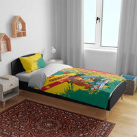 Red, green, and yellow bedding set on a bed with gray pillows, duvet with graphic center