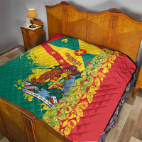 Quilted bedspread with Grenada flag print, red and yellow panels with teal border.