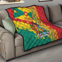 Quilted throw blanket draped on sofa with Grenada flag design and decorative foliage.