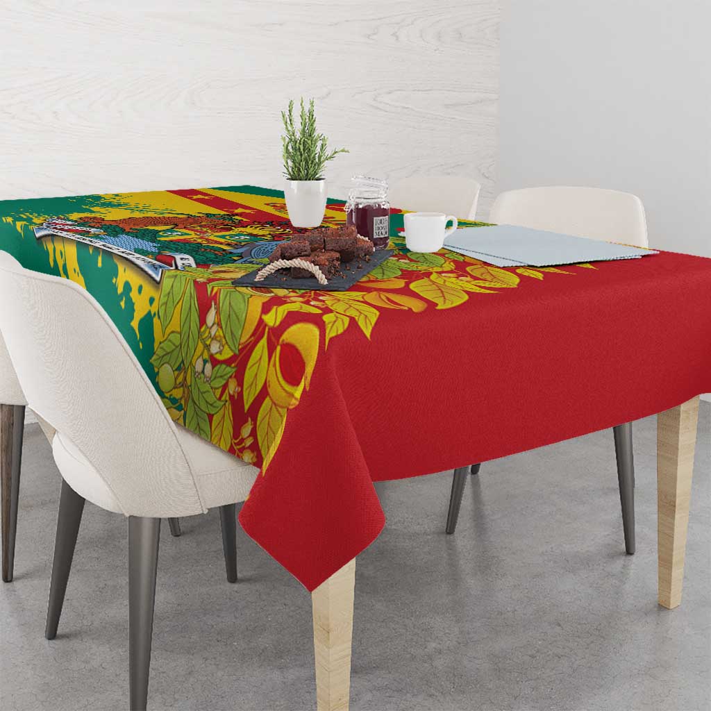 Tablecloth with red base, green border, and tropical leaf pattern with yellow details