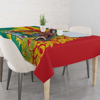 Tablecloth with red base, green border, and tropical leaf pattern with yellow details