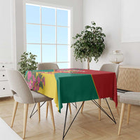 Grenada flag tablecloth draped on dining table, red green yellow with floral accents
