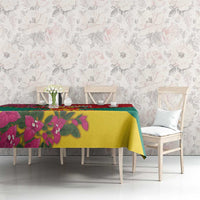 Grenada flag tablecloth on dining table with pink bougainvillea, yellow-green center, red edge