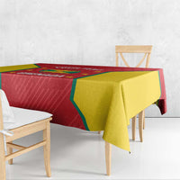 Red and yellow Grenada cricket tablecloth on benches with corner drop