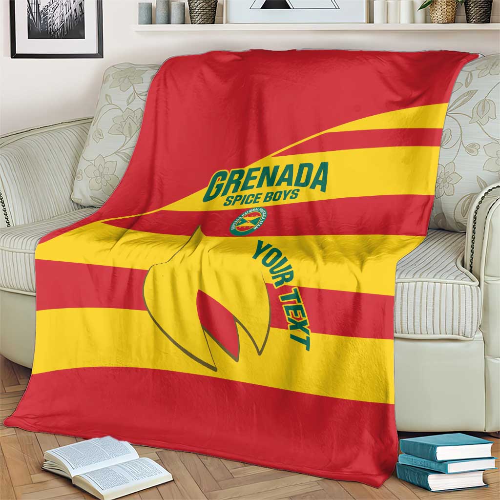 Red and yellow Grenada football blanket on couch, large diagonal stripe logo
