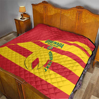 Red and yellow football quilt with Grenada Spice Boys logo on bed, diamond quilt stitching