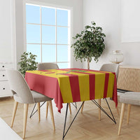 Red and yellow striped football tablecloth draped over dining table