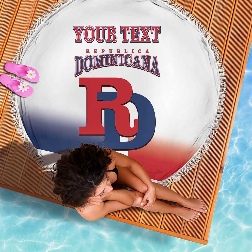 Close-up round beach blanket with fringe, white Dominican flag design and custom text, DB logo