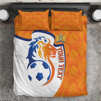 Orange and white soccer bedding set with lion logo, ball, and 'YOUR TEXT' on duvet