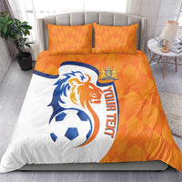 Orange and white soccer bedding set with lion logo, ball, and 'YOUR TEXT' on duvet