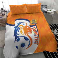Orange and white soccer bedding set with lion logo, ball graphic, and 'YOUR TEXT' text