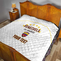 White quilt on bed with Venezuela emblem, “La Vinotinto” and “YOUR TEXT” print
