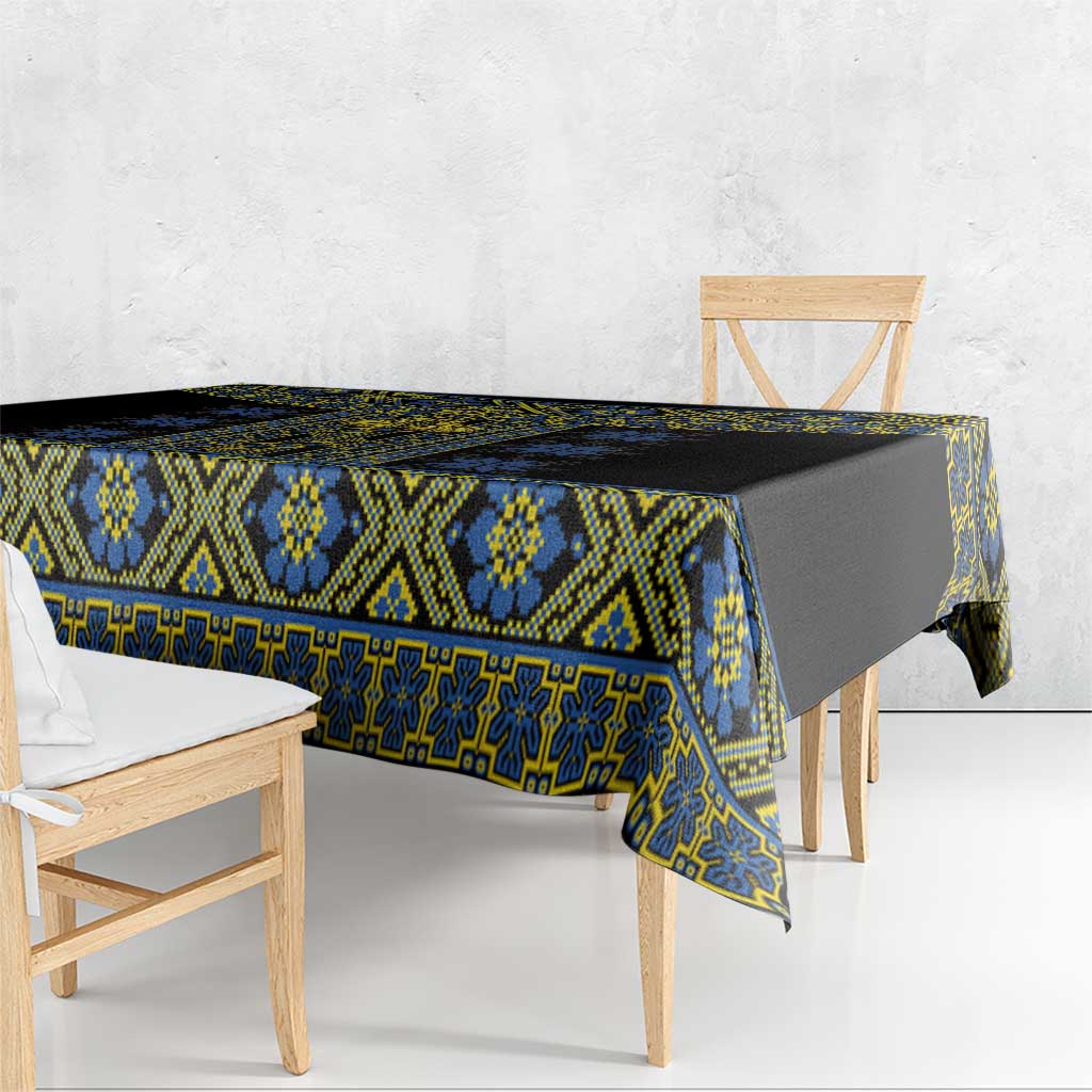 Black tablecloth with blue and yellow geometric border, corner drape shown.