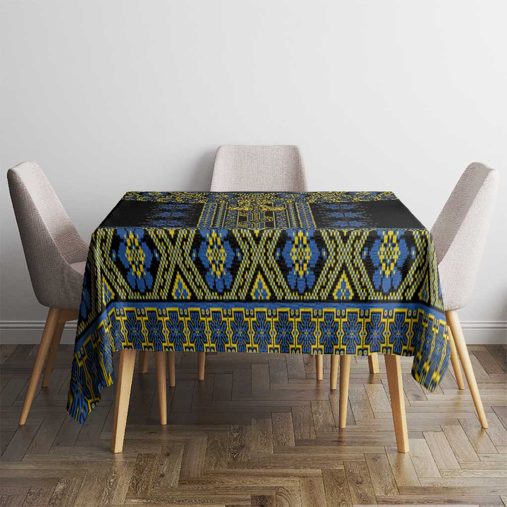 Rectangular black tablecloth with repeating blue and yellow folk pattern across center.