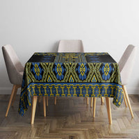 Rectangular black tablecloth with repeating blue and yellow folk pattern across center.
