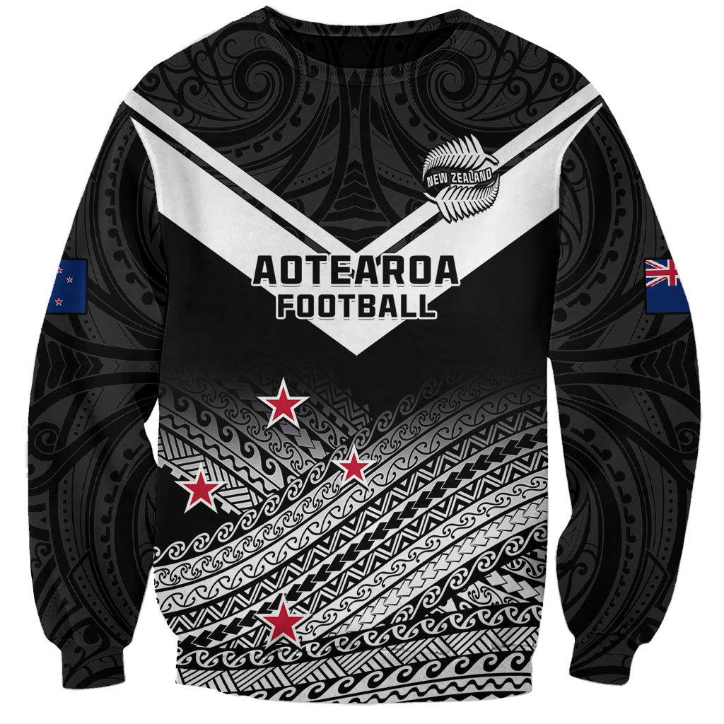 Unisex black football sweatshirt with Aotearoa graphic, Maori fern pattern, flags on sleeves