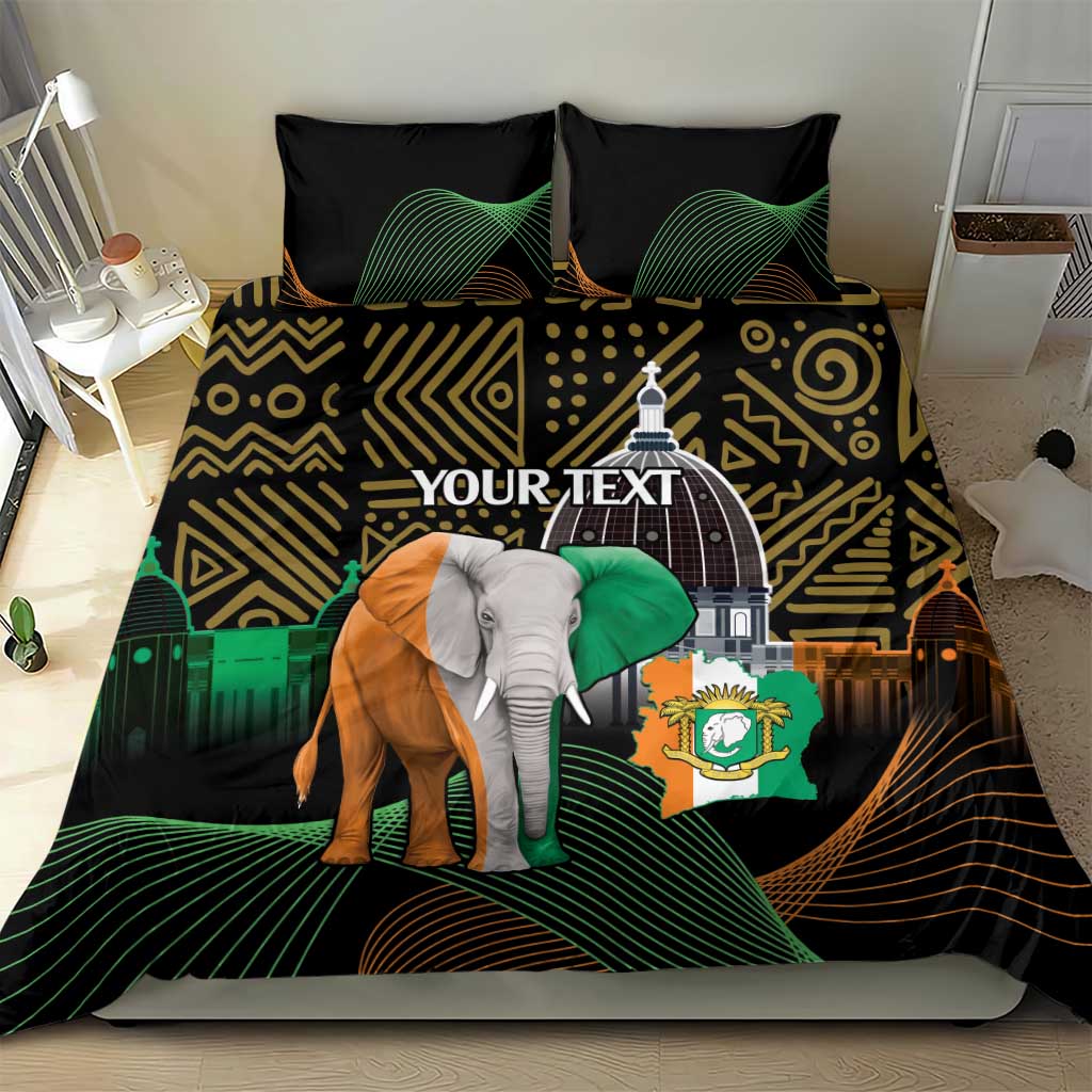 Black bedding set on bed with elephant graphic, gold zigzag shapes, and green arcs
