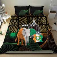 Black bedding set on bed with elephant graphic, gold zigzag shapes, and green arcs