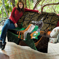 Personalized quilt held on outdoor bench with elephant and green flag on black geometric print