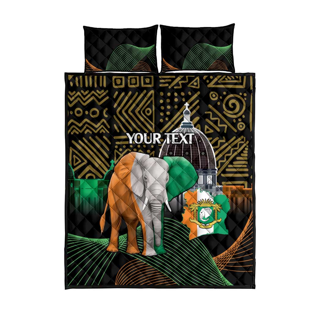 Black quilt bed set with elephant and arch motif, green accents, and two matching pillowcases