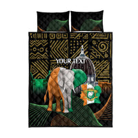 Black quilt bed set with elephant and arch motif, green accents, and two matching pillowcases