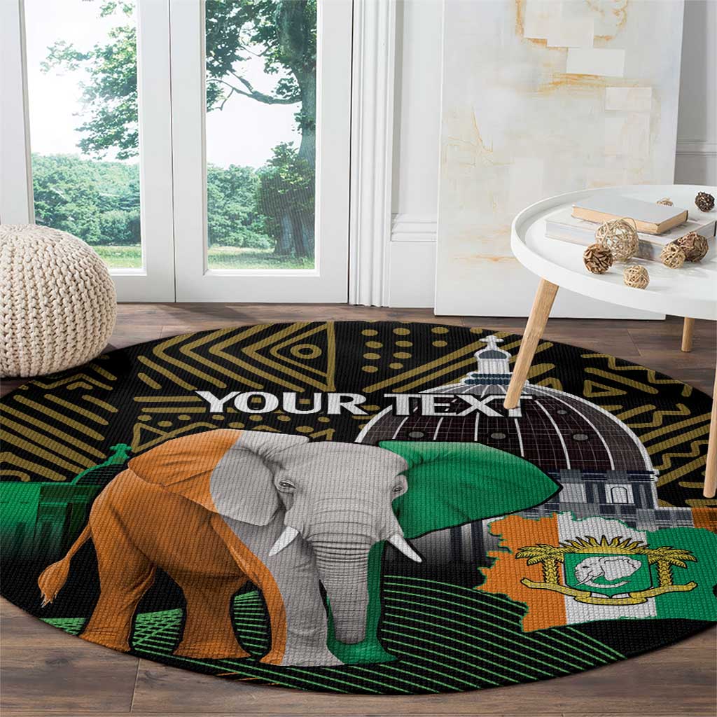 Round floor rug with black, green, and orange elephant graphic and arch emblem