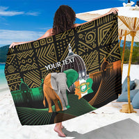 Black patterned sarong with elephant graphic and “YOUR TEXT” print, worn draped