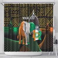 Shower curtain on rod with dark geometric print, elephant and Ivory Coast crest banner