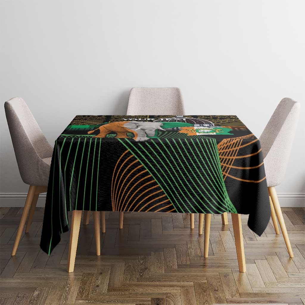 Black square tablecloth with green and gold African geometric design, elephant crest center