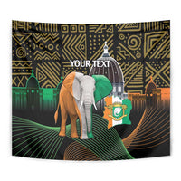 Personalized black tapestry close view: elephant with green head wrap over gold geometric designs.