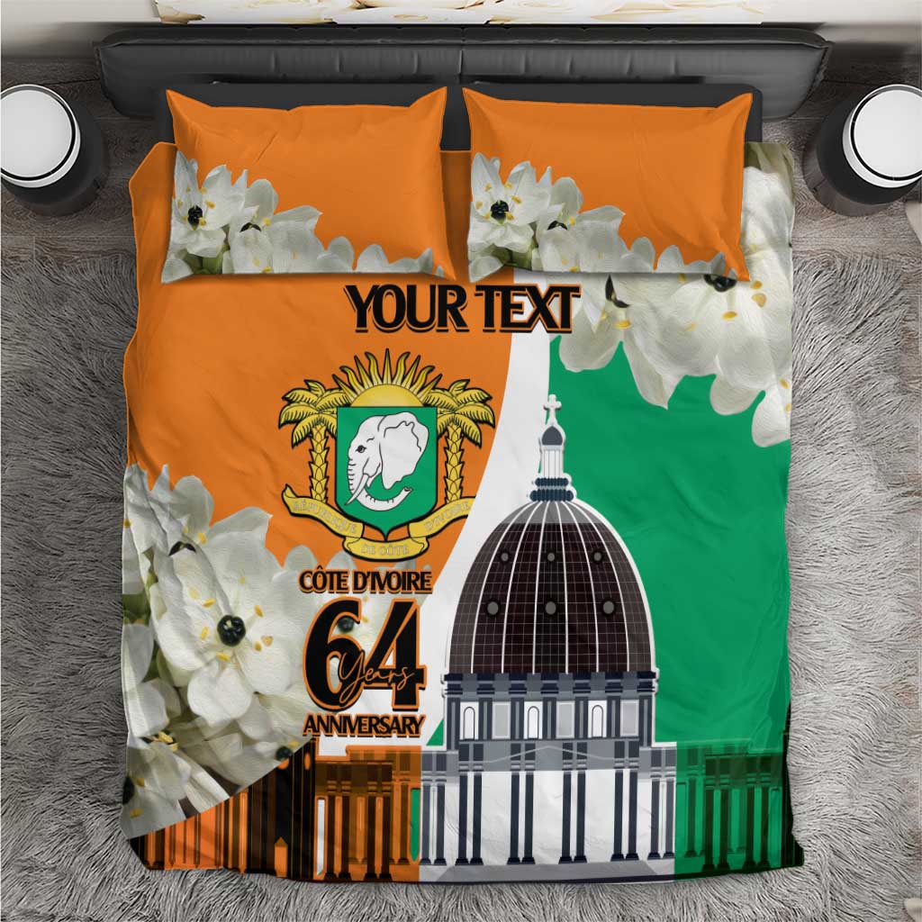 Orange bedding set with floral print, Ivory Coast emblem, dome graphic, and custom text