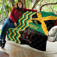 Custom Jamaica football quilt held up, green and yellow zigzag chevrons on black with star and your text