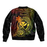 Black bomber jacket back with 'Hawaii' text and gold-green Polynesian tattoo style art