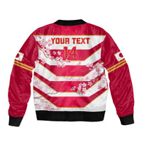 Red bomber jacket back, white chevron stripes with cherry blossoms, black ribbed collar