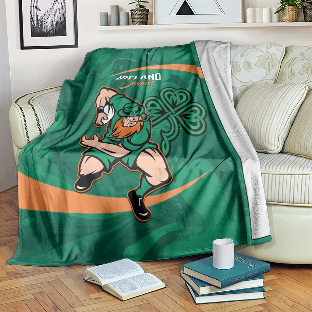 Green rugby blanket with orange stripe, shamrock pattern and running player graphic