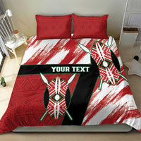 Red, white, and black bedding set featuring shield graphic duvet and two red patterned pillows
