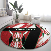 Round area rug with red-green-black-white design and 'YOUR TEXT' across the center