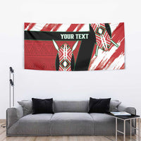 Wall-mounted red and white tapestry with tribal shield design and 'YOUR TEXT'