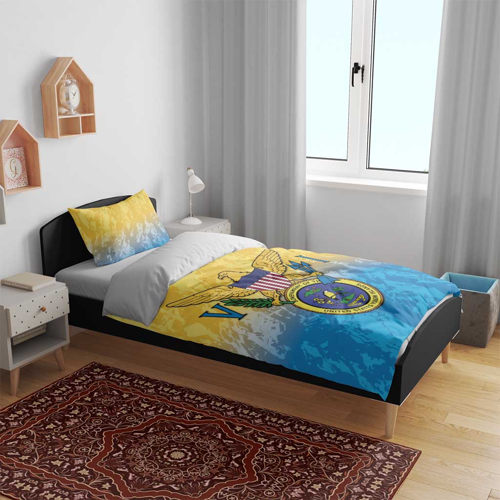 Yellow and blue comforter with Virgin Islands coat of arms crest, shown on bed