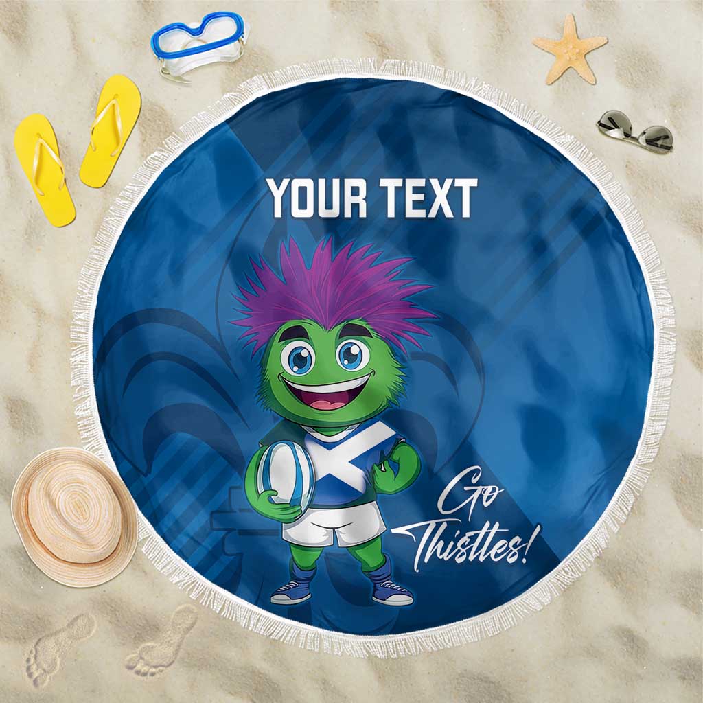 Blue round beach blanket with fringe, cartoon mascot and "Go Thistles!" slogan