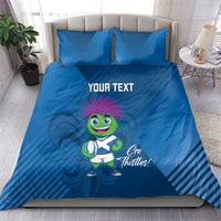 Blue duvet cover set with two pillows featuring thistle mascot and 'YOUR TEXT' centered