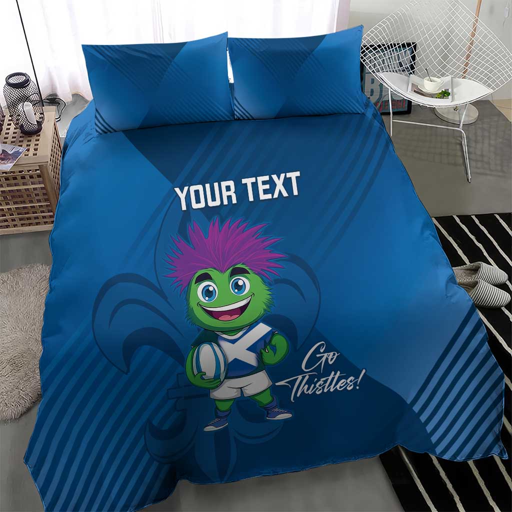 Blue duvet cover set with two pillows; thistle mascot character and 'YOUR TEXT' in middle